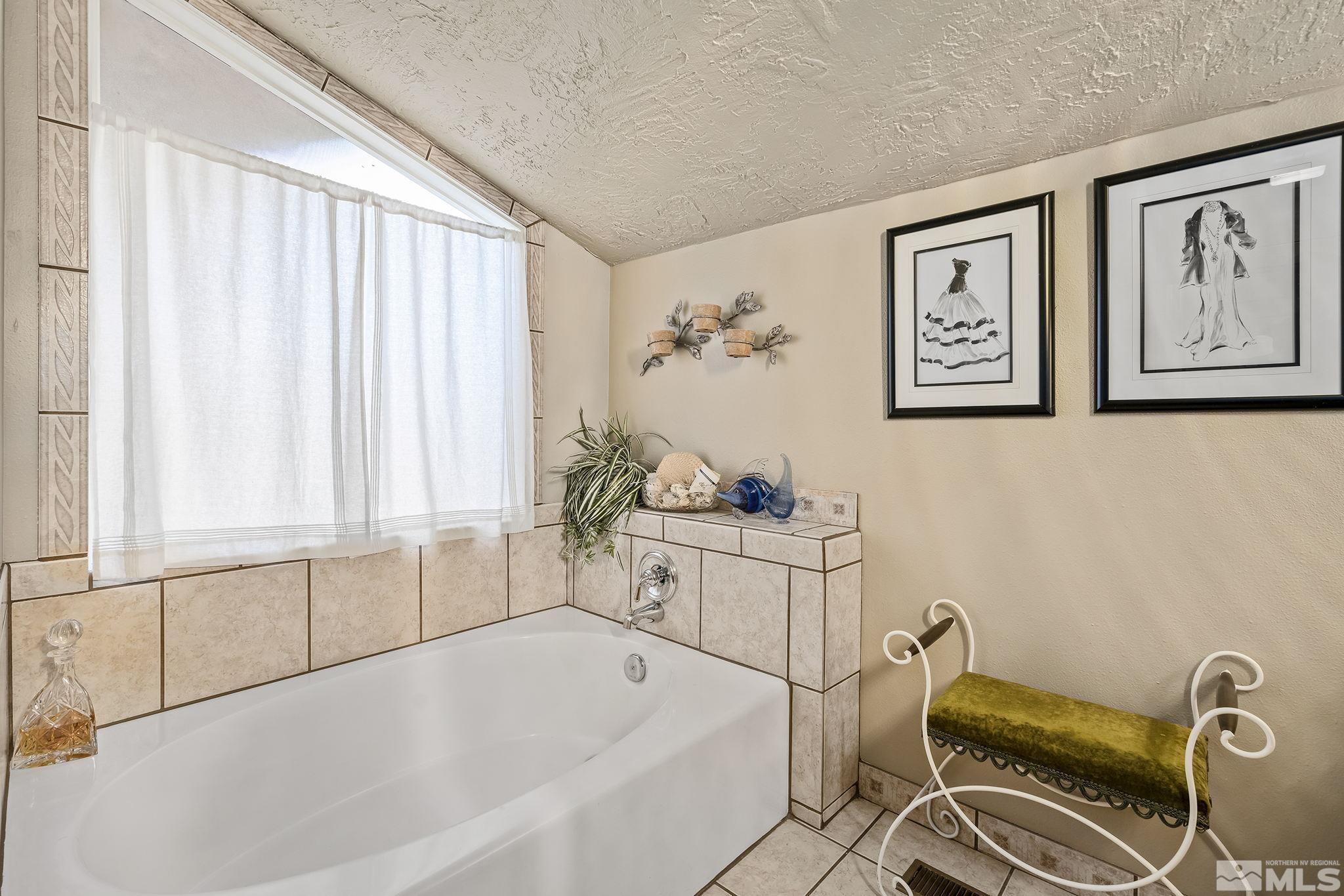 1947 South Villa Way Reno, NV 89509 - Photo 21 of 27 a bathroom with a sink and a bathtub