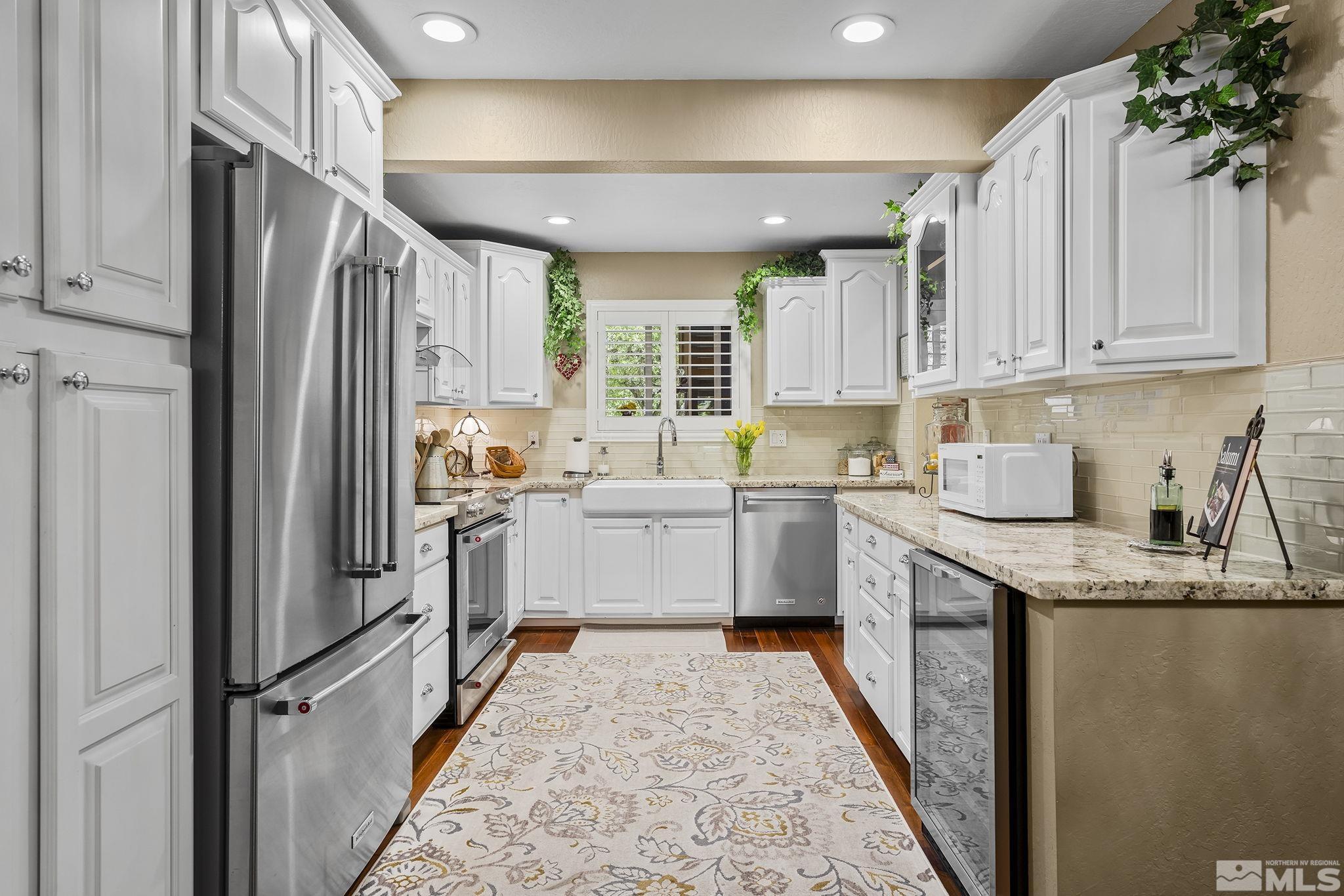 1947 South Villa Way Reno, NV 89509 - Photo 7 of 27 a kitchen with a refrigerator sink stove and cabinets