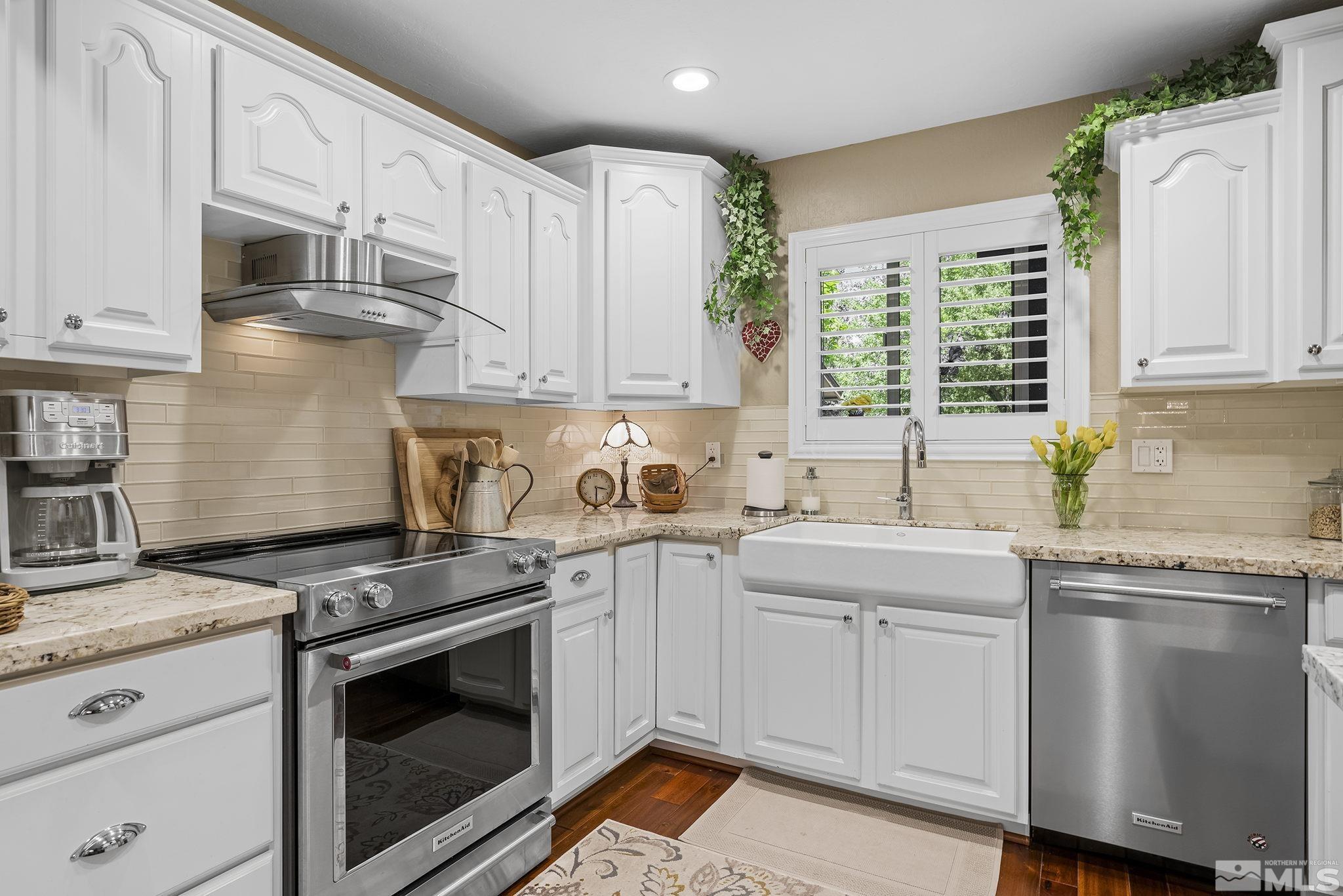 1947 South Villa Way Reno, NV 89509 - Photo 8 of 27 a kitchen with stainless steel appliances granite countertop a sink stove and cabinets