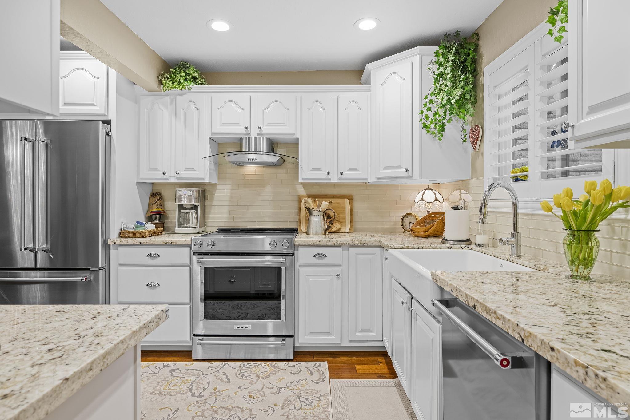 1947 South Villa Way Reno, NV 89509 - Photo 9 of 27 a kitchen with granite countertop a sink stove and refrigerator