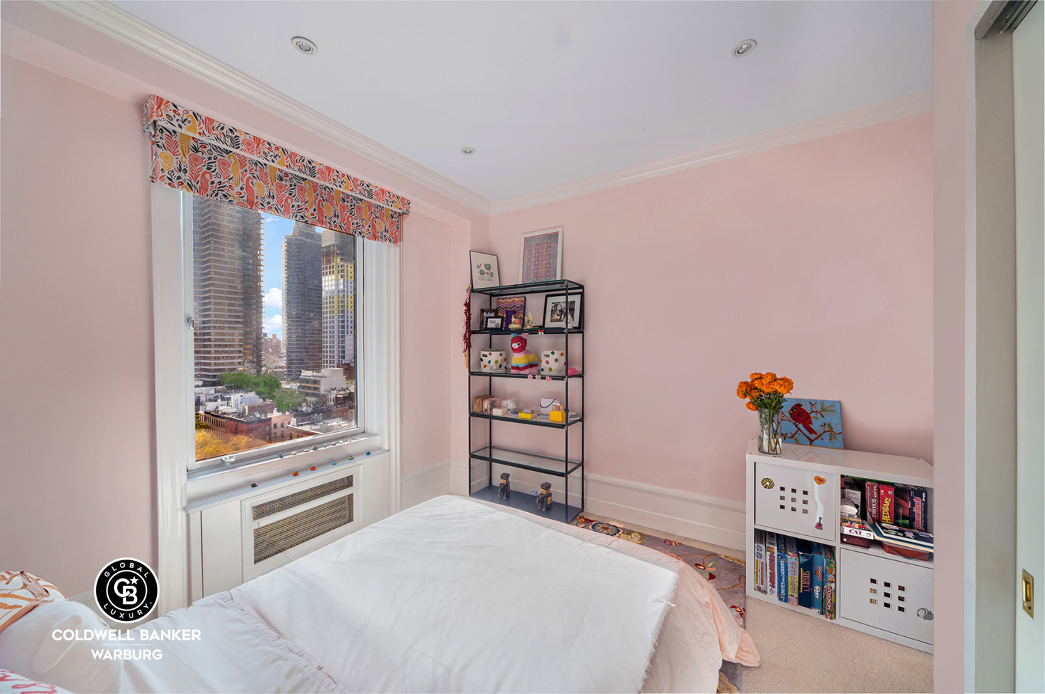 565 Park Avenue, Unit 11E Manhattan, NY 10065 - Photo 6 of 11 a bedroom with a bed and a book shelf