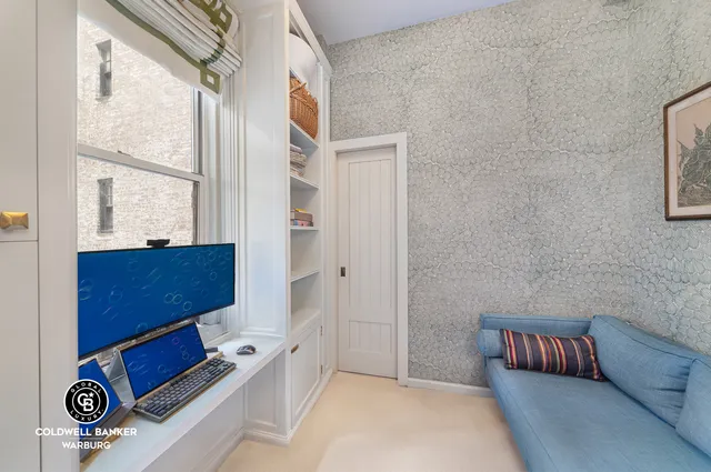 a bedroom with a bed and a book shelf