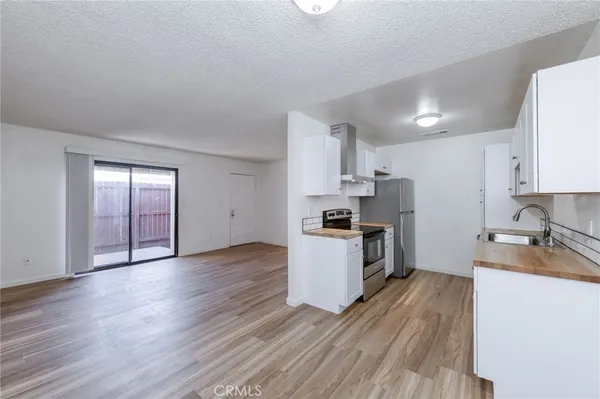 a kitchen with wooden floors and white appliances