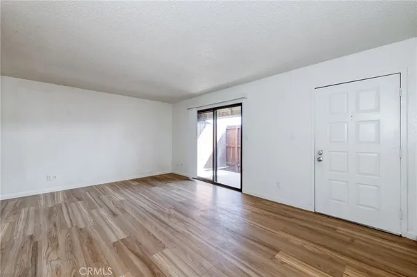 a view of an empty room and wooden floor