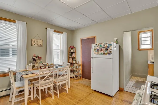 a dining room with furniture a window and stainless steel appliances