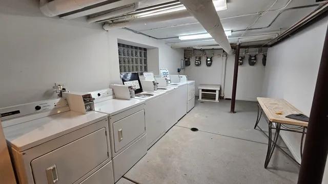 a view of a storage & utility room with two washing machine