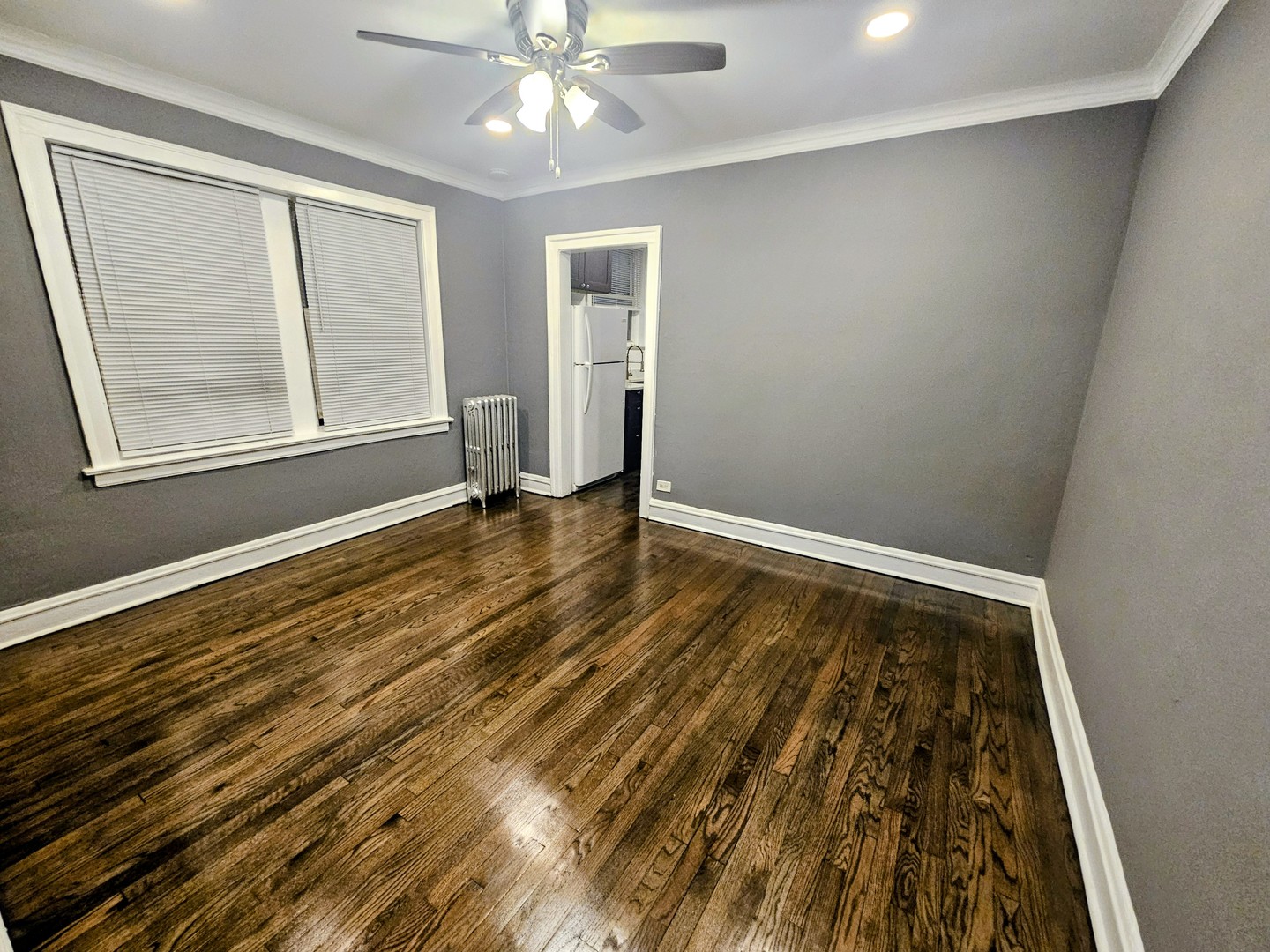6545 North Francisco Avenue, Unit 1A Chicago, IL 60645 - Photo 3 of 12 wooden floor in an empty room with a window