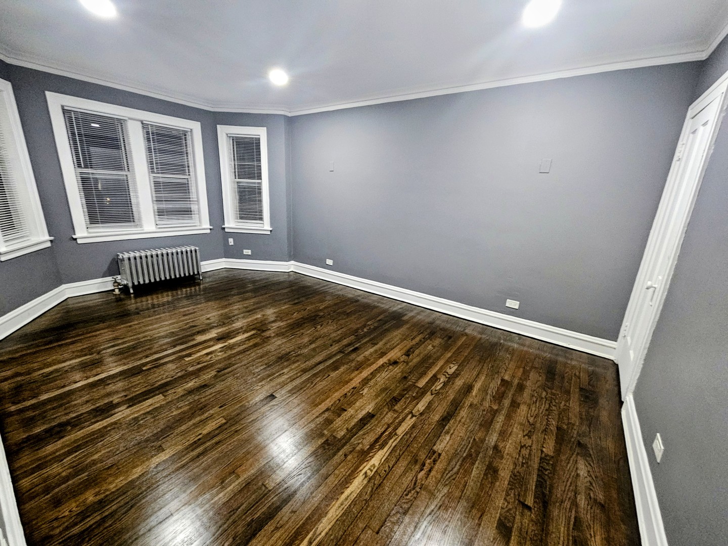 6545 North Francisco Avenue, Unit 1A Chicago, IL 60645 - Photo 6 of 12 en empty room with wooden floor and windows
