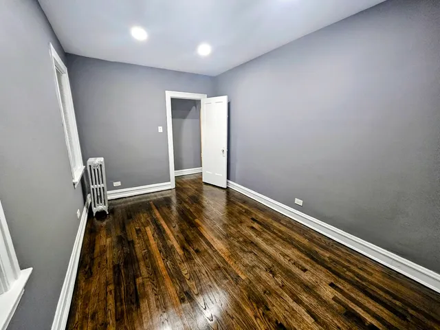 a view of room with wooden floor