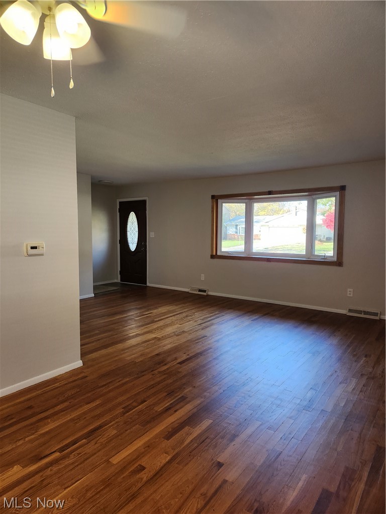 4660 West Farnhurst Road South Euclid, OH 44121 - Photo 4 of 17 Unfurnished room with dark hardwood / wood-style flooring and ceiling fan