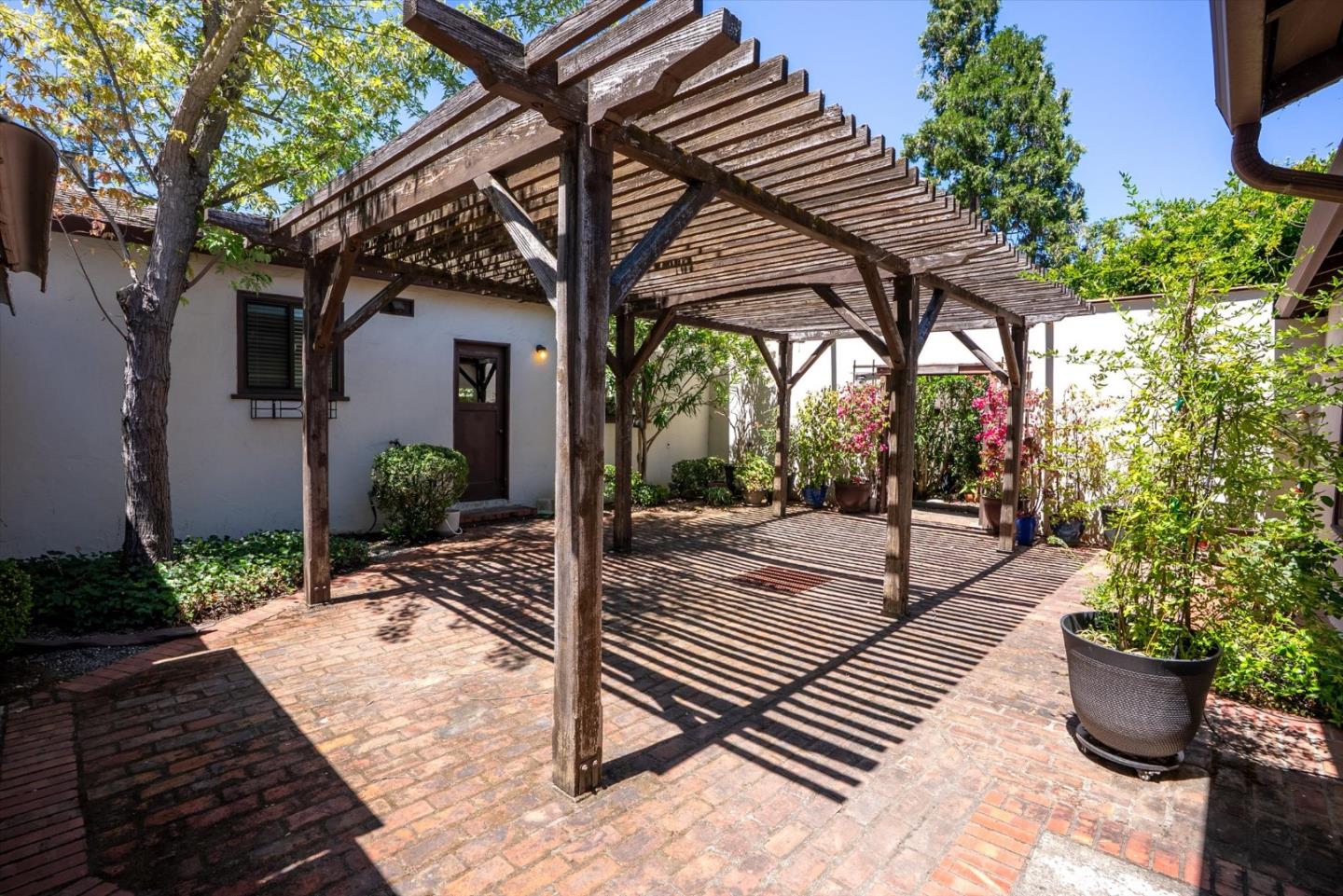 16899 Kennedy Road Los Gatos, CA 95032 - Photo 38 of 61 a view of a patio with table and chairs potted plants and floor to ceiling window