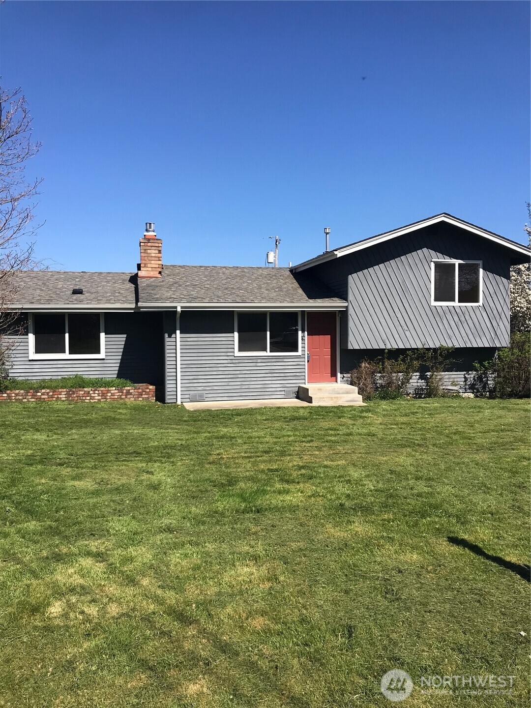 1214 36th Street Anacortes, WA 98221 - Photo 1 of 23 a front view of a house with a garden