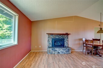 1214 36th Street Anacortes, WA 98221 - Photo 12 of 23 an empty room with fireplace and wooden floor