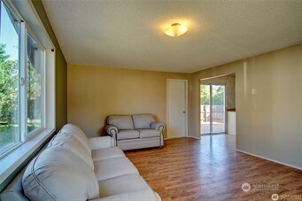 1214 36th Street Anacortes, WA 98221 - Photo 16 of 23 a living room with furniture and a large window
