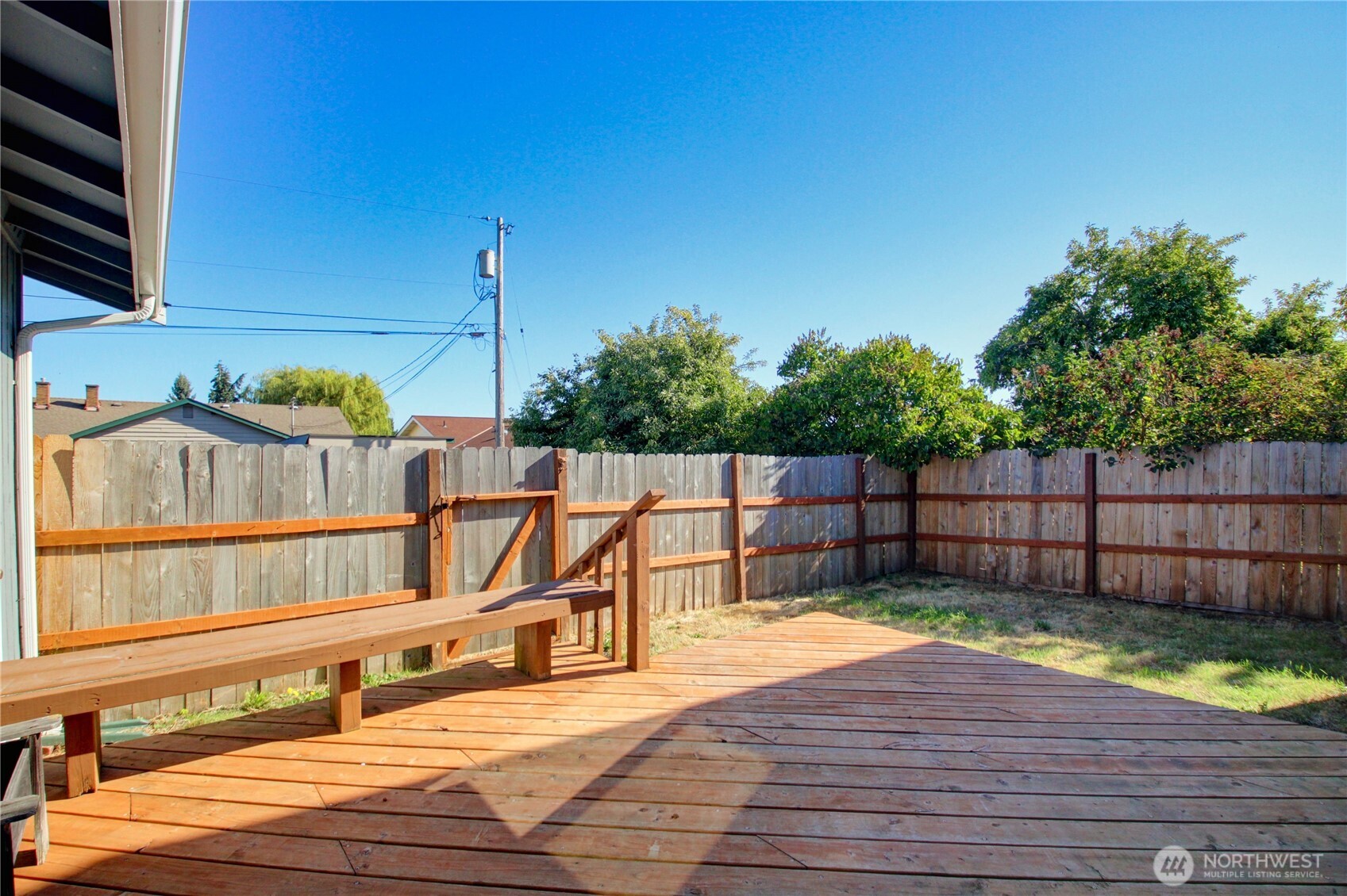 1214 36th Street Anacortes, WA 98221 - Photo 20 of 23 a view of a deck with a chair and floor to ceiling window