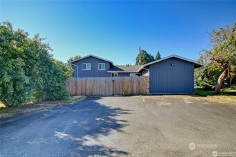 1214 36th Street Anacortes, WA 98221 - Photo 3 of 23 a house with trees in the background