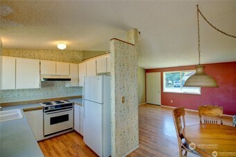 1214 36th Street Anacortes, WA 98221 - Photo 4 of 23 a kitchen with stainless steel appliances a stove a refrigerator and a microwave