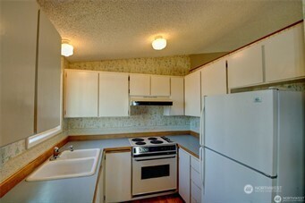 1214 36th Street Anacortes, WA 98221 - Photo 5 of 23 a kitchen with a refrigerator and a sink