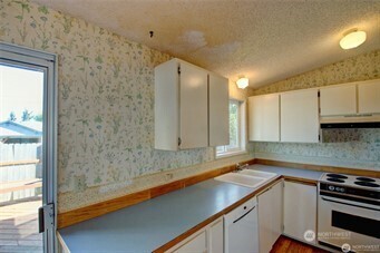 1214 36th Street Anacortes, WA 98221 - Photo 7 of 23 a kitchen with a sink and cabinets