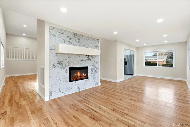 a view of a kitchen with a fireplace and wooden floor