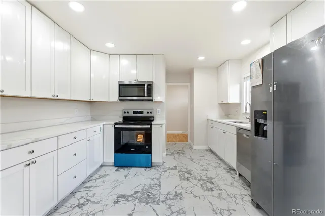 a kitchen with stainless steel appliances granite countertop a refrigerator sink and cabinets