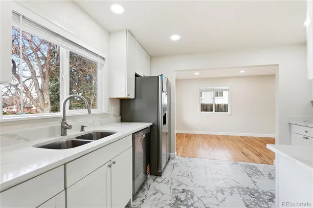 a kitchen with a sink and refrigerator