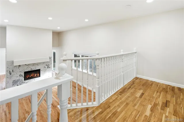 a view of front door with wooden floor and stairs