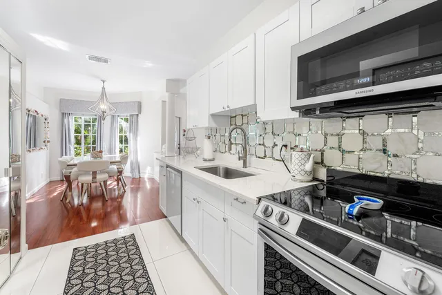a kitchen with a sink stove and cabinets