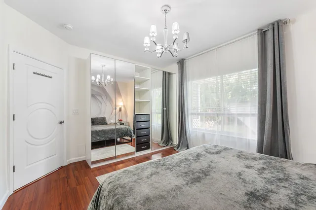 a bedroom with a large bed and a window