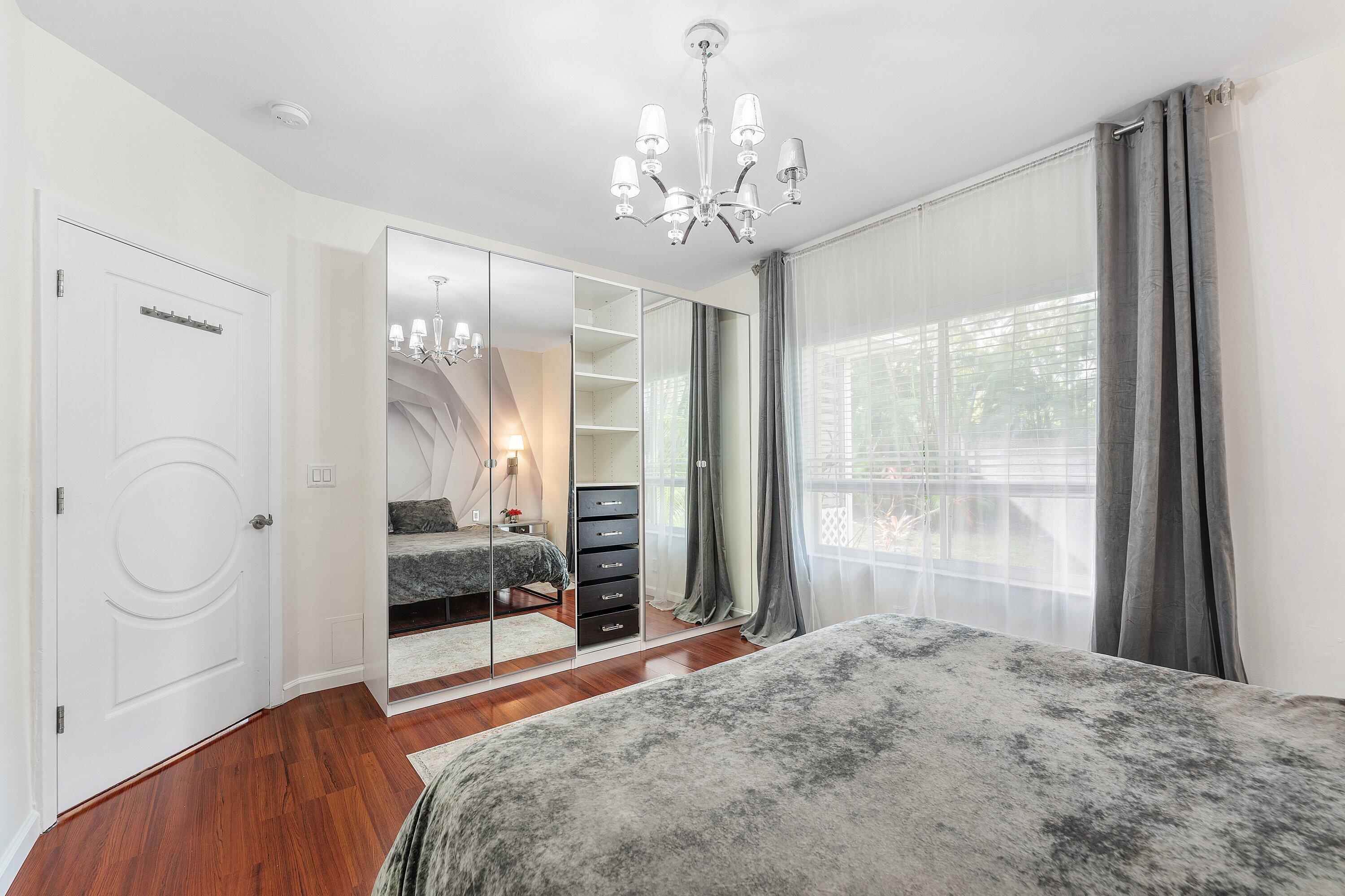 20 South Lakeshore Drive, Unit C Hypoluxo, FL 33462 - Photo 21 of 55 a bedroom with a large bed and a window