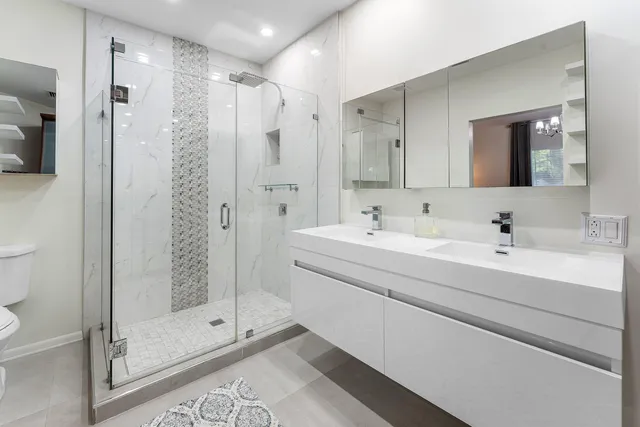 a bathroom with a shower sink and mirror