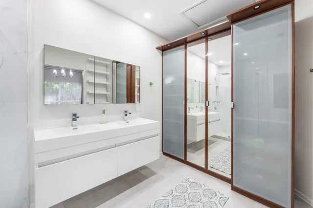 a bathroom with a bathtub and a double vanity sink