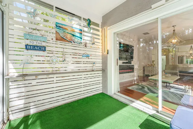 a view of a balcony and dining room