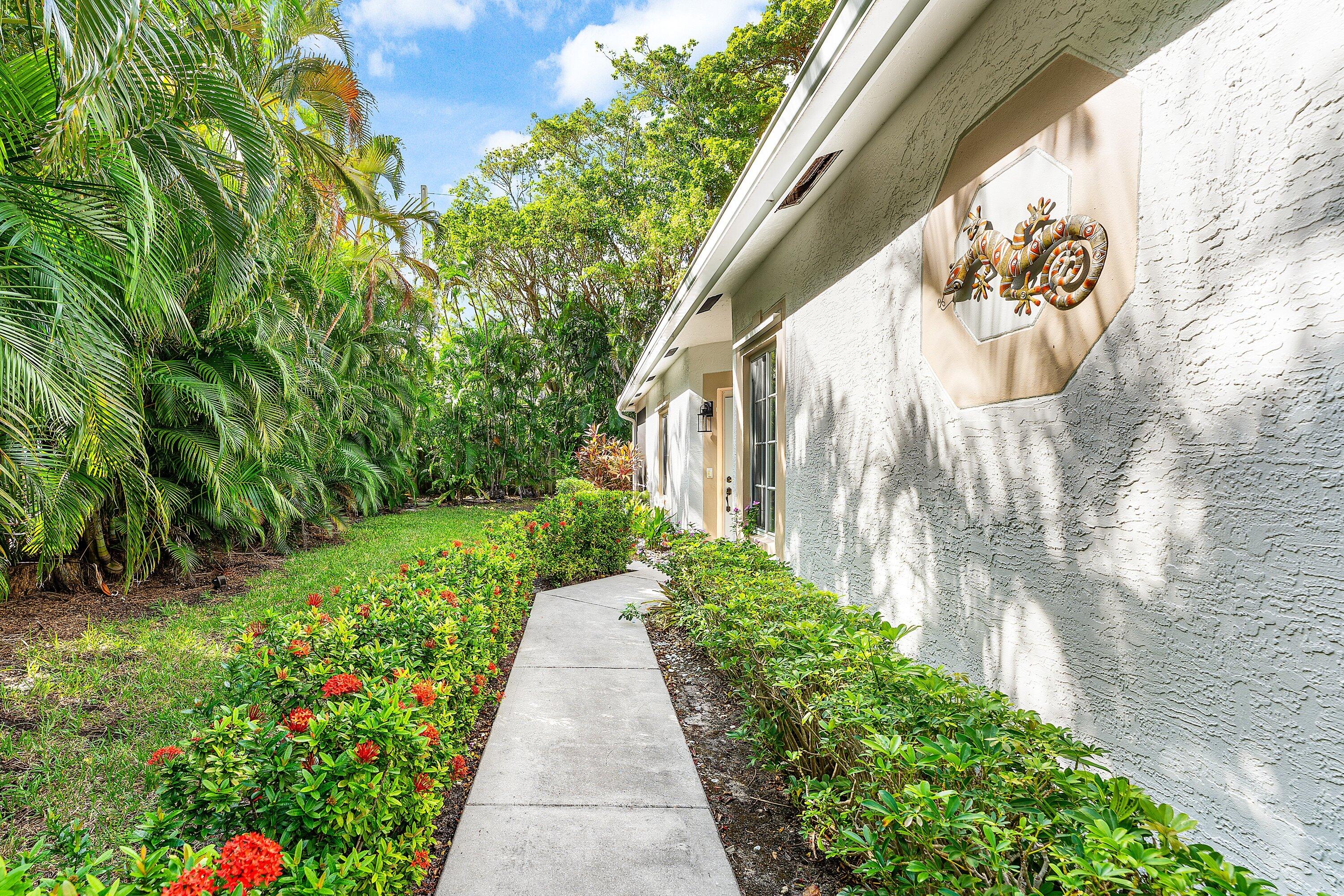 20 South Lakeshore Drive, Unit C Hypoluxo, FL 33462 - Photo 31 of 55 a view of a pathway with a flower garden