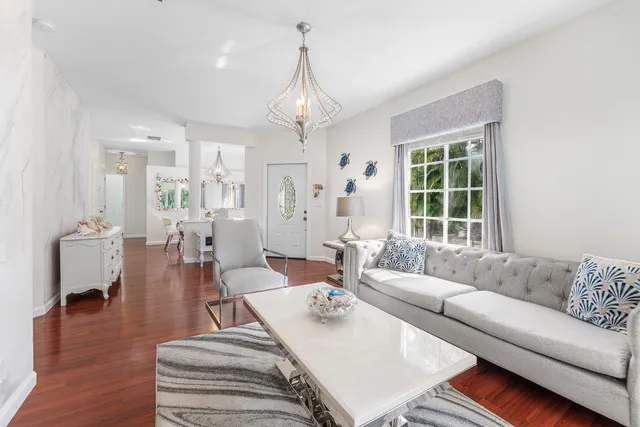 a living room with furniture and a chandelier