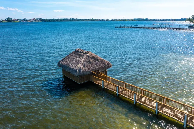 a view of a backyard with a patio and swimming pool