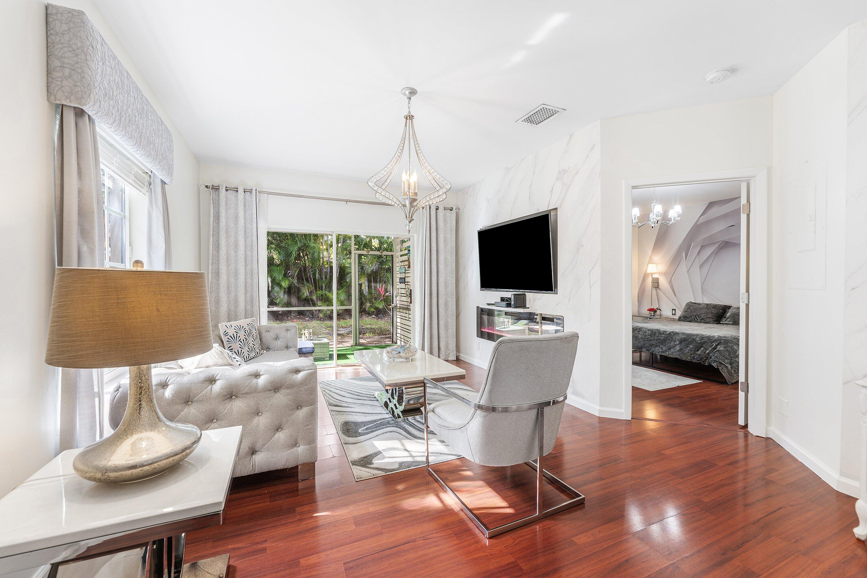 20 South Lakeshore Drive, Unit C Hypoluxo, FL 33462 - Photo 5 of 55 a living room with furniture fireplace and a flat screen tv
