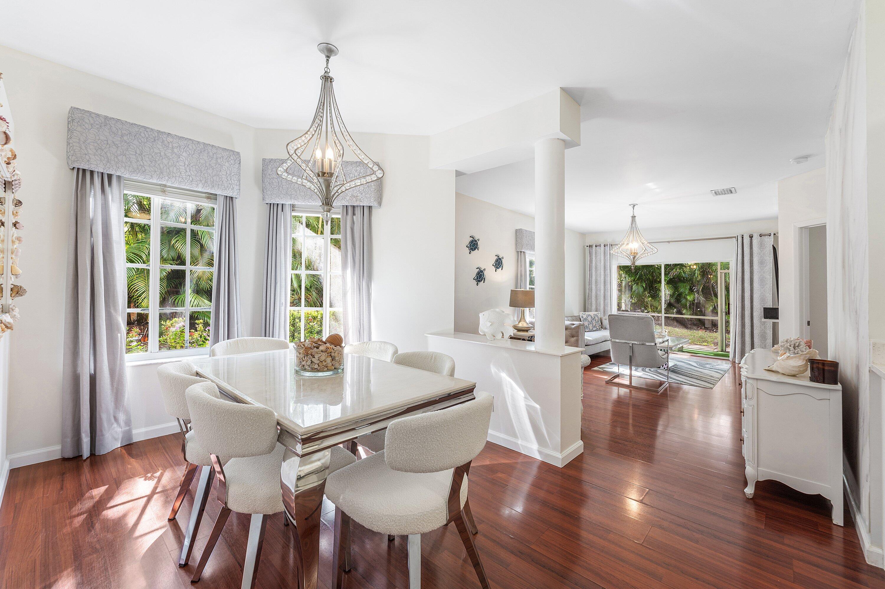 20 South Lakeshore Drive, Unit C Hypoluxo, FL 33462 - Photo 9 of 55 a view of a dining room with furniture window and wooden floor