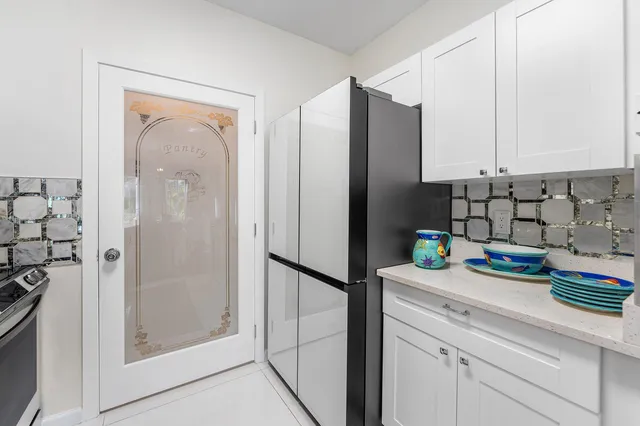 a kitchen with stainless steel appliances granite countertop a refrigerator and a sink