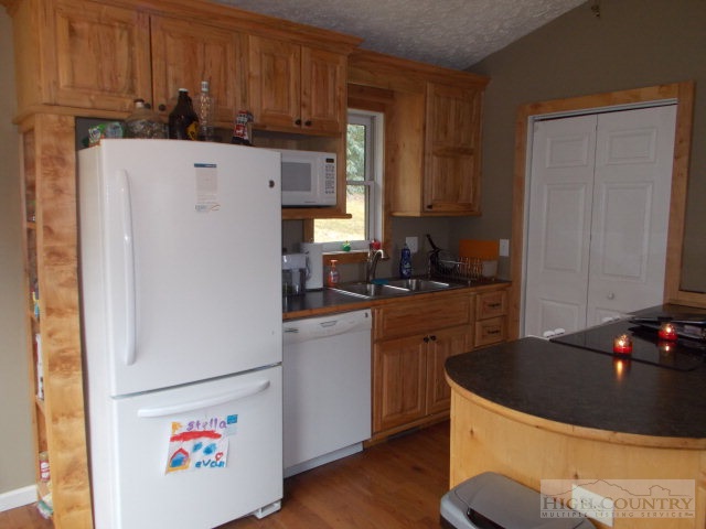 191 V L Moretz Road Deep Gap, NC 28618 - Photo 5 of 7 a kitchen with a refrigerator and a stove top oven