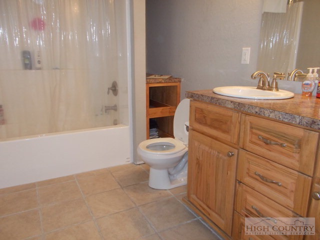 191 V L Moretz Road Deep Gap, NC 28618 - Photo 7 of 7 a bathroom with a toilet a sink and mirror