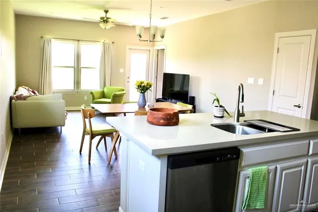 a kitchen with a table chairs and a flat screen tv