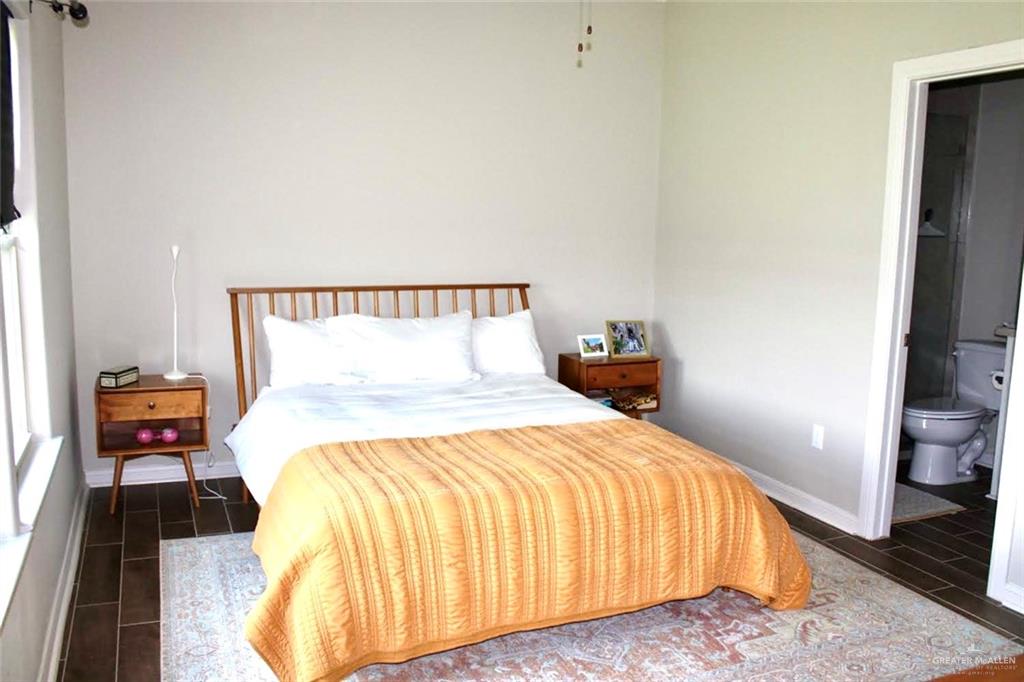 708 South Tecate Drive Mission, TX 78572 - Photo 5 of 10 a bedroom with a bed and wooden floor