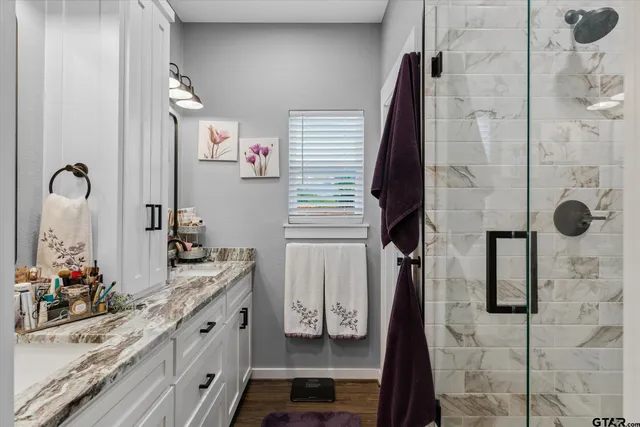 a bathroom with a double vanity sink and mirror