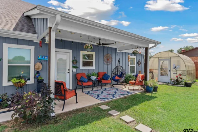 a group of people sitting in front of a house