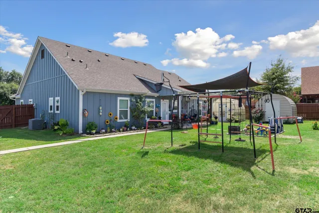 a view of an house with backyard and patio