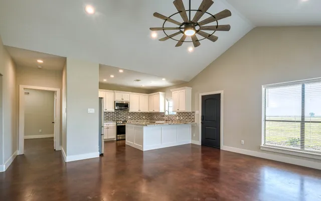 a kitchen with stainless steel appliances granite countertop a sink stove and cabinets
