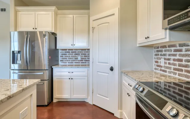 an empty room with a window and a ceiling fan