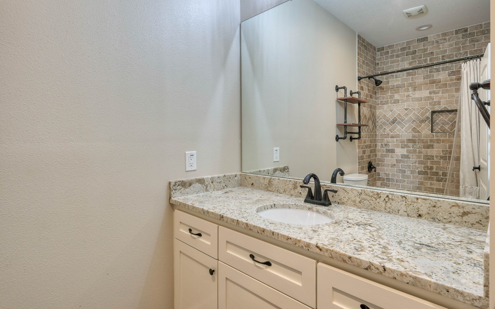 40934 Thomas Lane Hempstead, TX 77445 - Photo 25 of 50 a bathroom with a granite countertop sink and a mirror