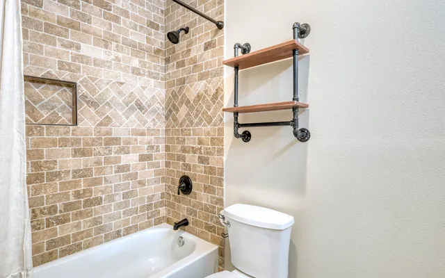 a view of a bathroom with a shower and a window